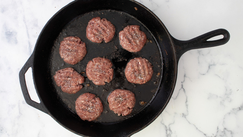 burger patties in frying pan