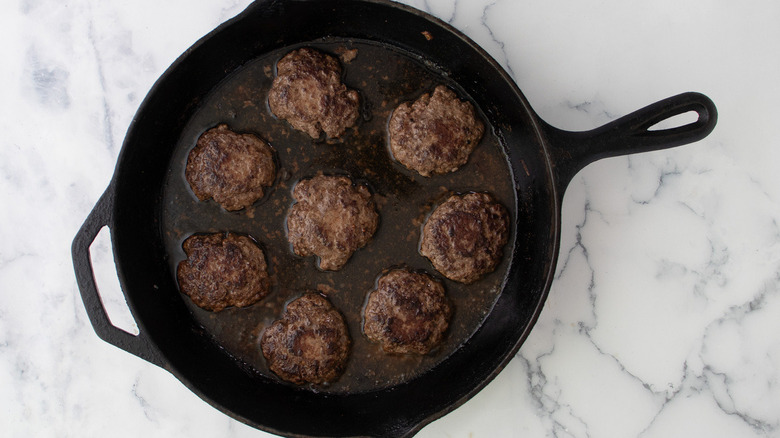 burger patties in frying pan