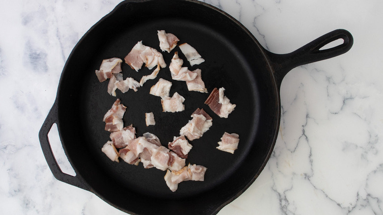 raw bacon in frying pan