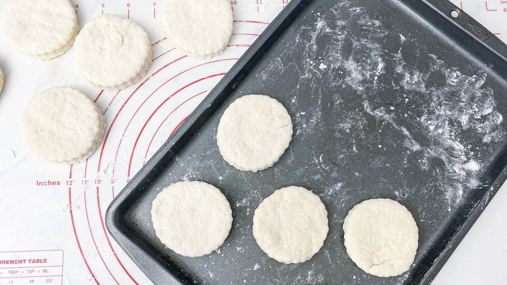 cut biscuit dough on baking sheet