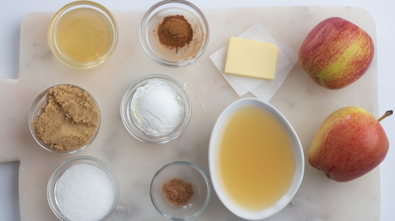 fried apple ingredients on cutting board in bowls