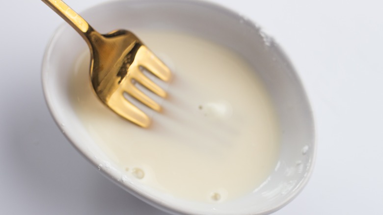 fork mixing cornstarch mixture in small bowl