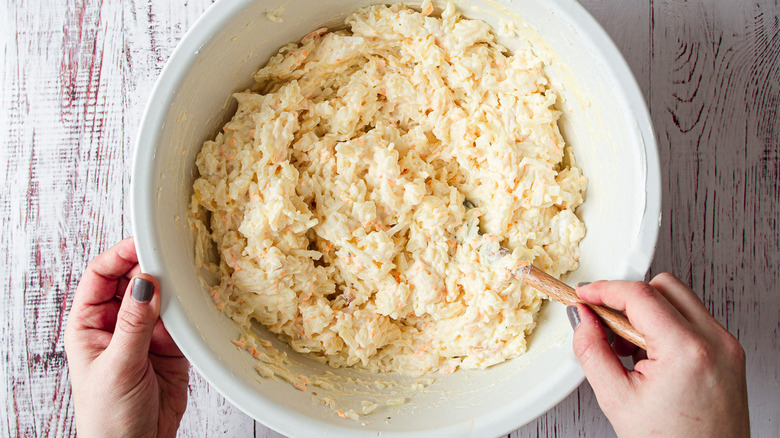 hands mixing casserole batter