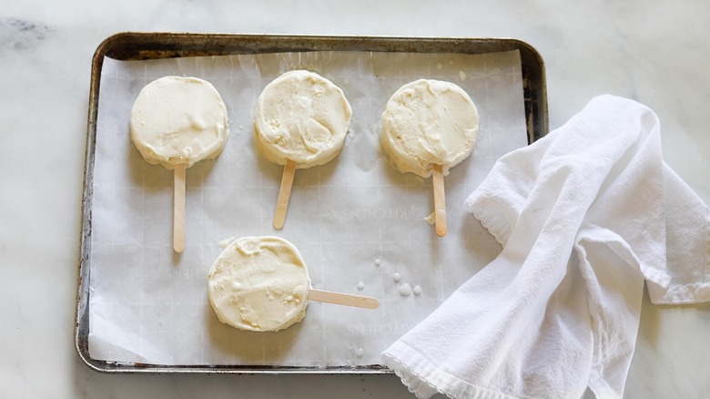 Ice cream popsicles on a baking sheet