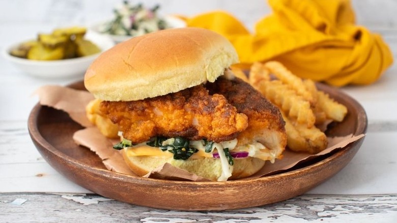 Hot chicken sandwich on plate with crinkle fries