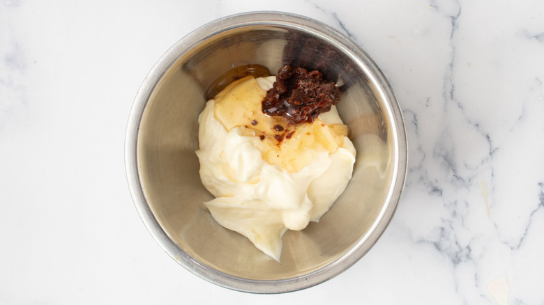 Mayonnaise, honey, chipotle peppers in bowl