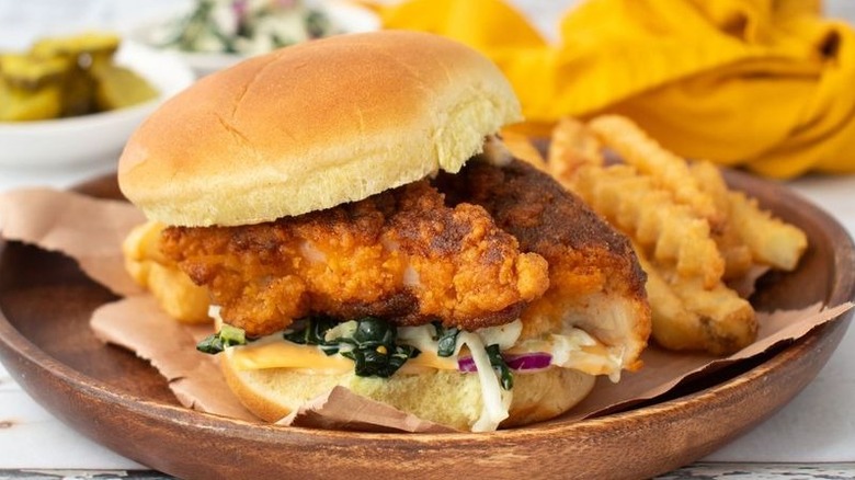 Hot chicken sandwich on plate with crinkle fries