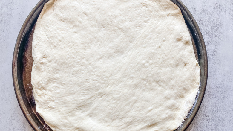 Pizza dough on pan