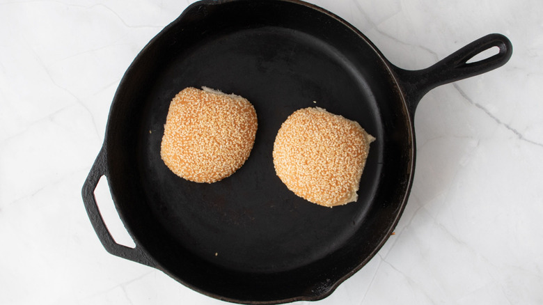 Sesame seed buns in skillet