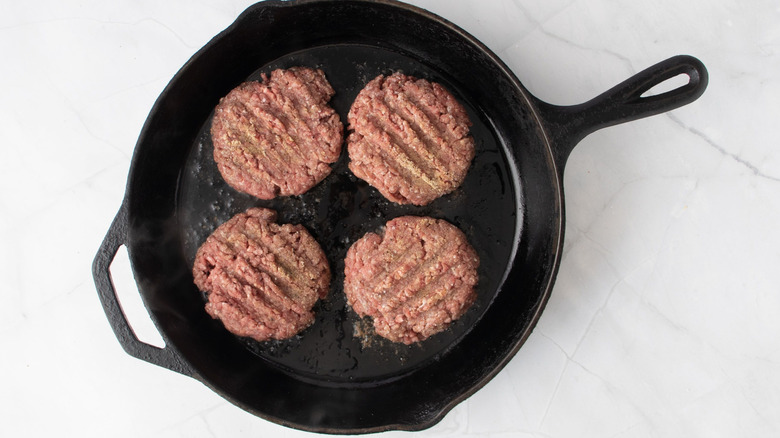 Beef patties in skillet