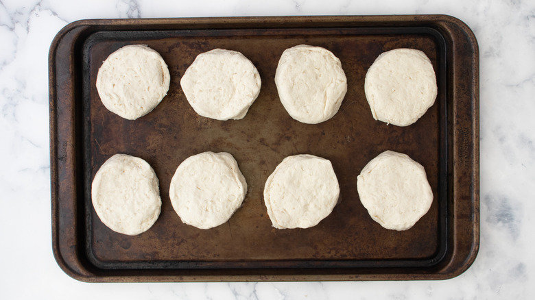 raw biscuits on baking sheet