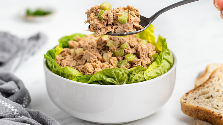 eating tuna salad with fork 