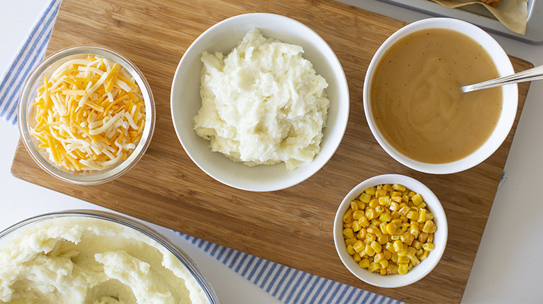 Bowl of corn, bowl of mashed potatoes, and bowl of gravy