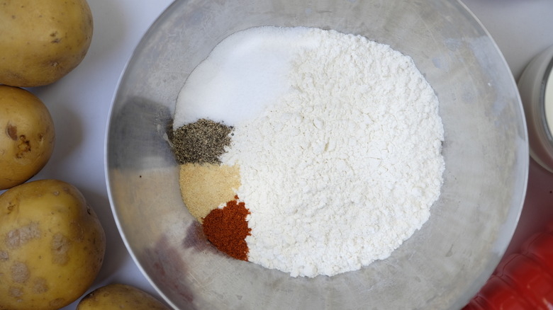 Spices in a bowl and milk and egg in another bowl