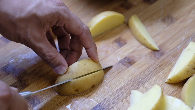 Slicing potatoes with a chef's knife