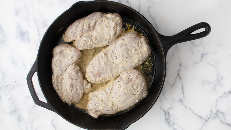 Marinated chicken in cast iron skillet