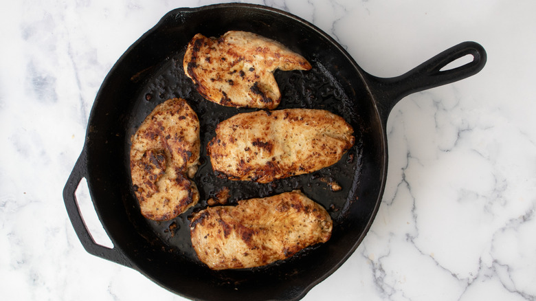 Seared chicken breasts in skillet