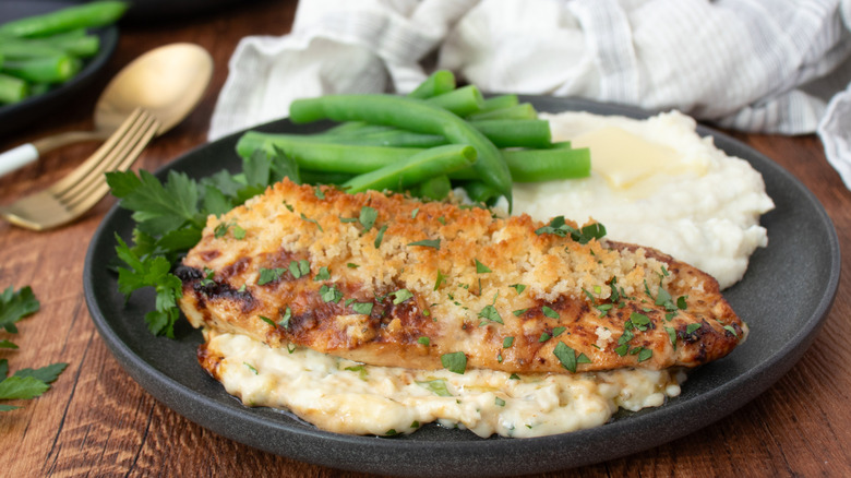 Parmesan crusted chicken, mashed potatoes, and green beans on plate