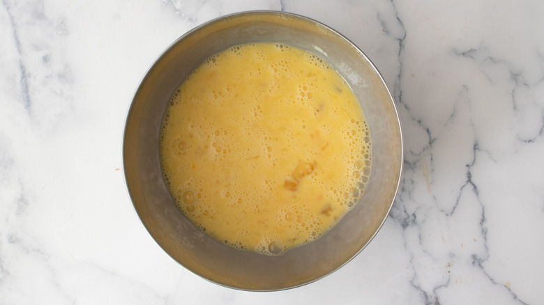 Egg mixture in metal mixing bowl