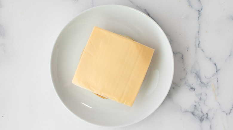 American cheese-covered mound on a white plate