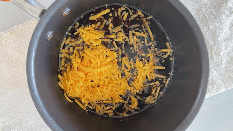 cheese and other ingredients in pot