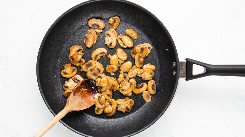 mushrooms and garlic in frying pan