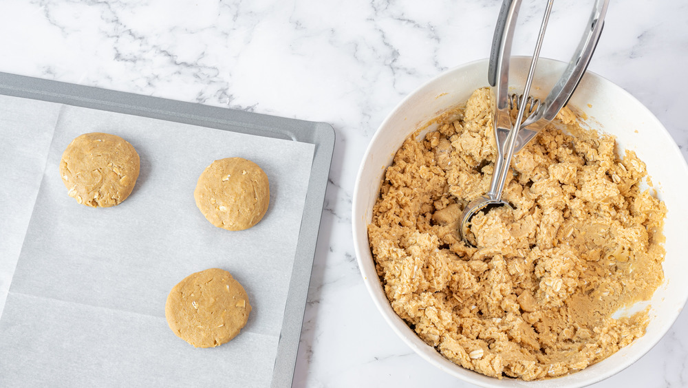 scooping cookie dough for copycat oatmeal cream pies