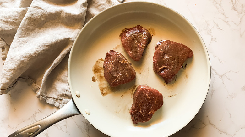 Steak medallions in pan