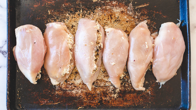 stuffed chicken breasts on baking sheet