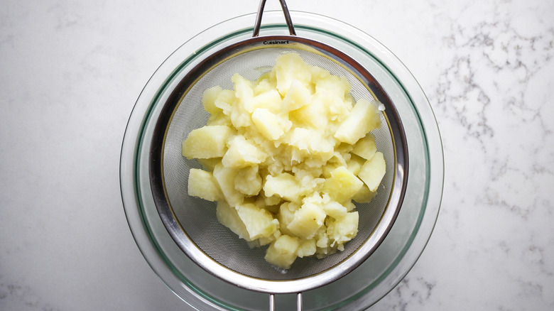 draining potatoes in colander