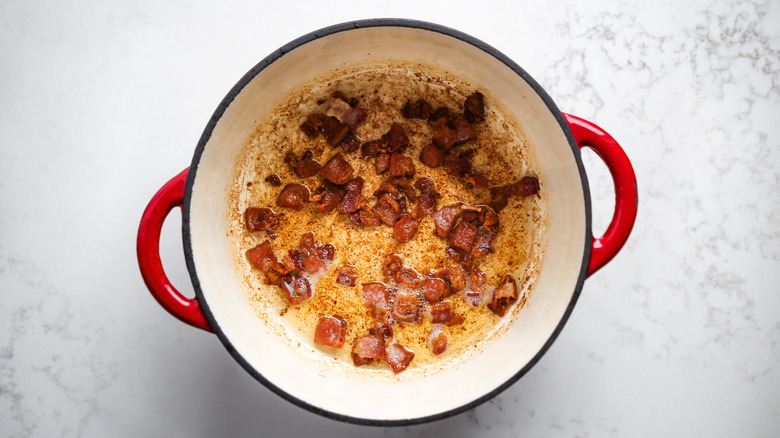 chopped bacon cooking in pot