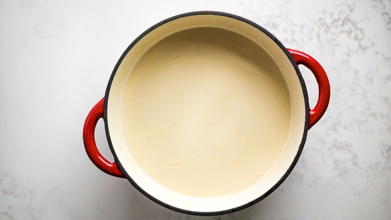 cream and broth in pot