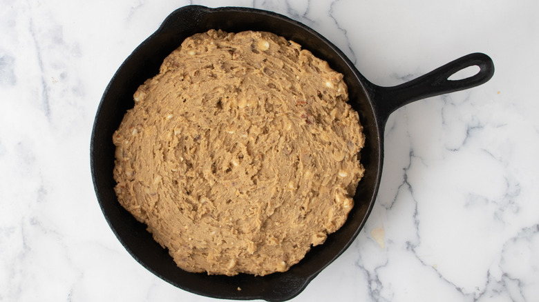 Brown cookie dough in a cast iron frying pan