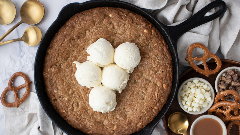 Skillet cookie topped with vanilla ice cream