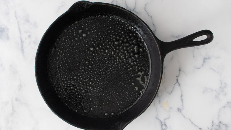 Cast iron frying pan coated with cooking spray