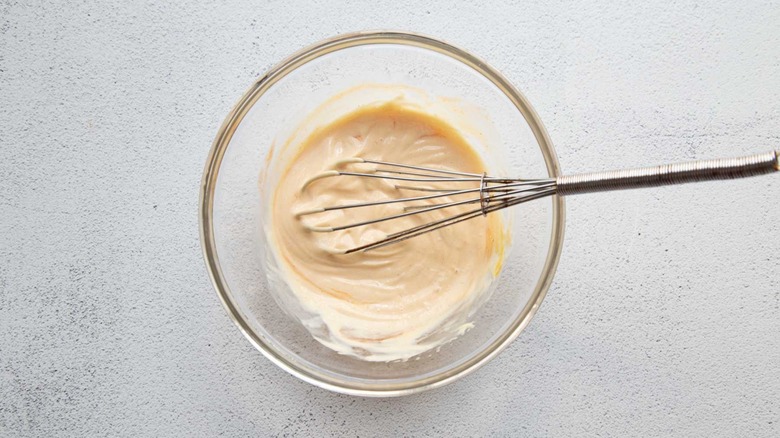 mayonnaise sauce with a whisk