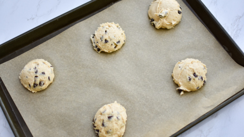 uncooked chocolate chip muffies on a baking sheet