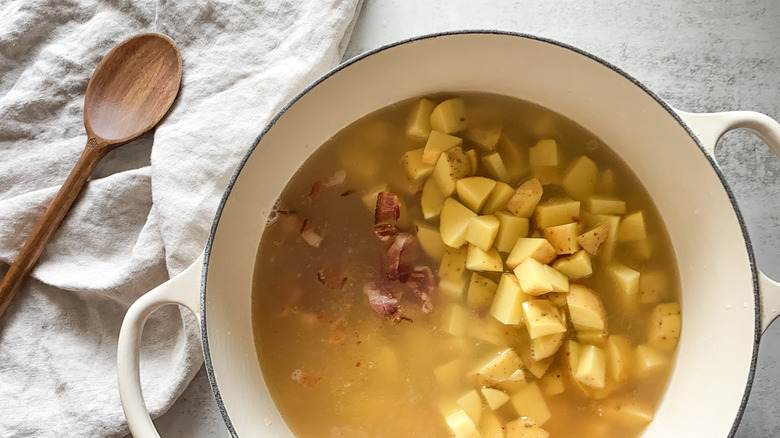 potatoes, bacon, broth in pot 