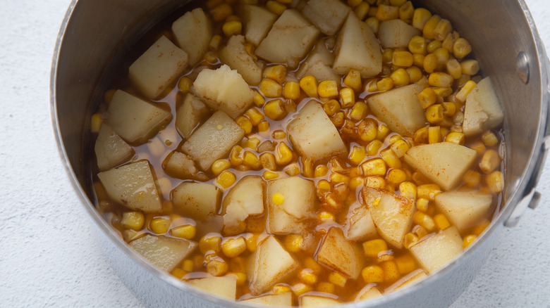 potatoes and corn in saucepan