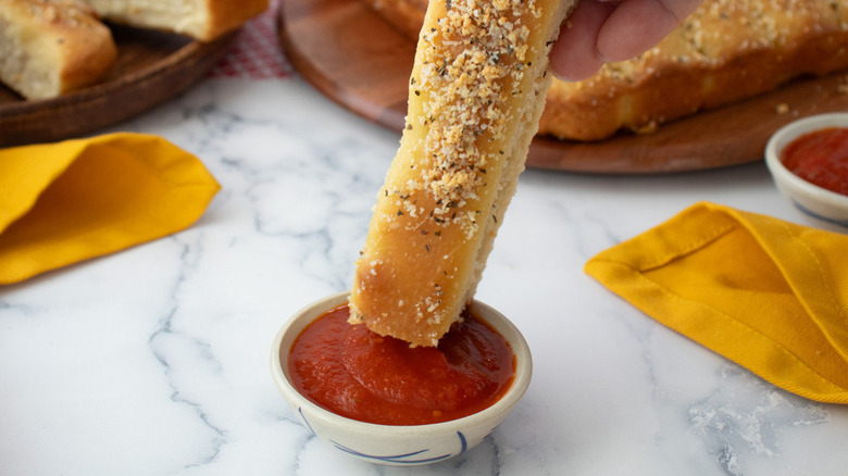 breadstick dipping into sauce