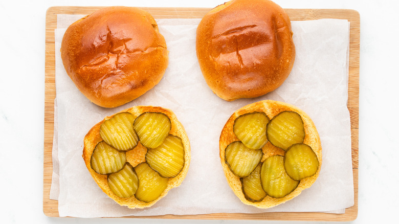 toasted brioche buns with sliced pickles