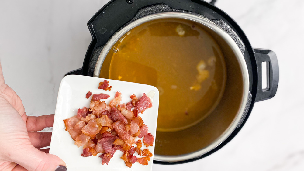 bacon on cutting board over Instant Pot for copycat Popeyes red beans and rice