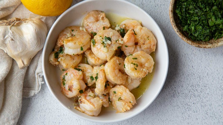 shrimp scampi in shallow white dish