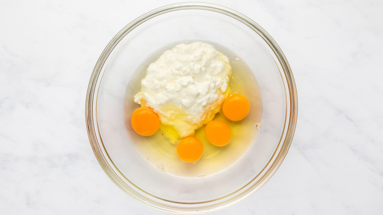 Eggs and cottage cheese in glass mixing bowl