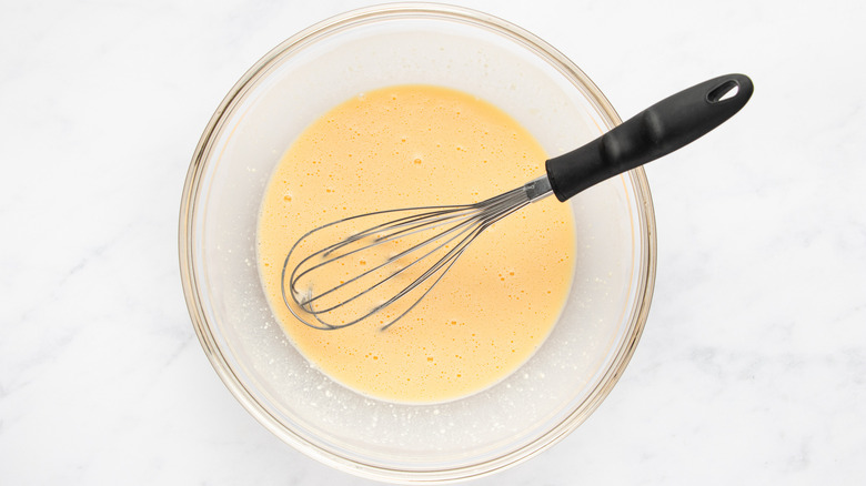 Egg and cottage cheese mixture whisked in mixing bowl