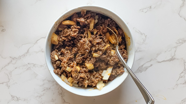 Ground beef in a bowl with onions