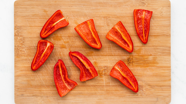 Sliced red chiles on wood cutting board