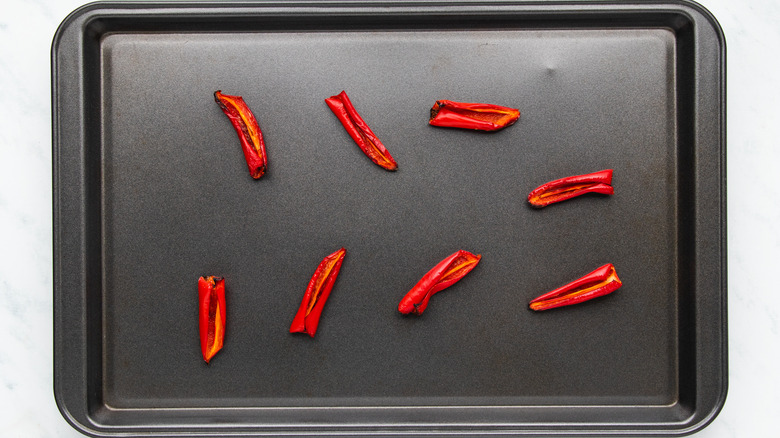 Roasted red chiles on baking sheet
