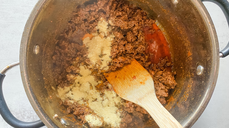 Copycat Wick Fowler's 2 alarm chili recipe in pot with spices