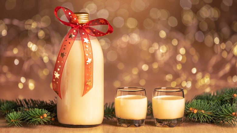 Bottle of coquito with bow and glasses